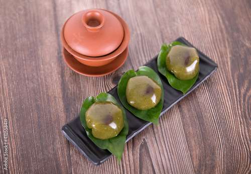 A plate of food for Qingming Festival, glutinous rice, wormwood, green dumplings and a bowl of tea photo