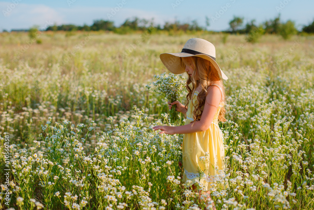 little girl in a straw hat in the field