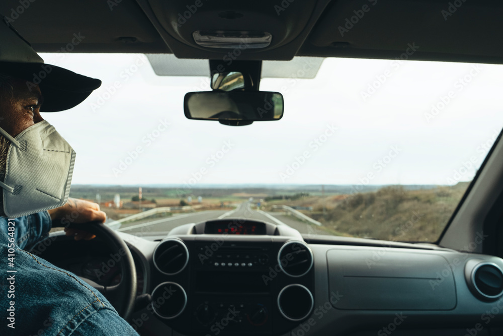 A man driving a van with a protective mask Protective measures against coronavirus A man driving a van with a protective mask Protective measures against coronavirus