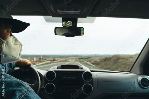 A man driving a van with a protective mask Protective measures against coronavirus © jcalvera