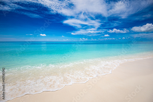 Closeup of sand on beach and blue summer sky. Panoramic beach landscape. Empty tropical beach and seascape. Blue sky, soft sand, calmness, tranquil relaxing sunlight, summer mood. Travel vacation