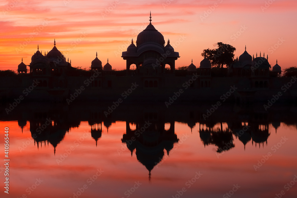 Kusum Sarovar at the red sunset. A historical sandstone monument located on the holy Govardhan Hill between Manasi Ganga and Radha Kund in District Mathura of Uttar Pradesh in India

