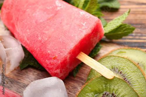 Delicious watermelon ice cream on wooden background, closeup