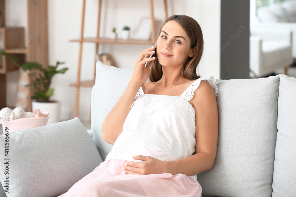 Beautiful pregnant woman talking by mobile phone at home Beautiful pregnant woman talking by mobile phone at home