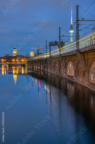 The River Spree, the Television Tower and a moving train in Berlin at dusk