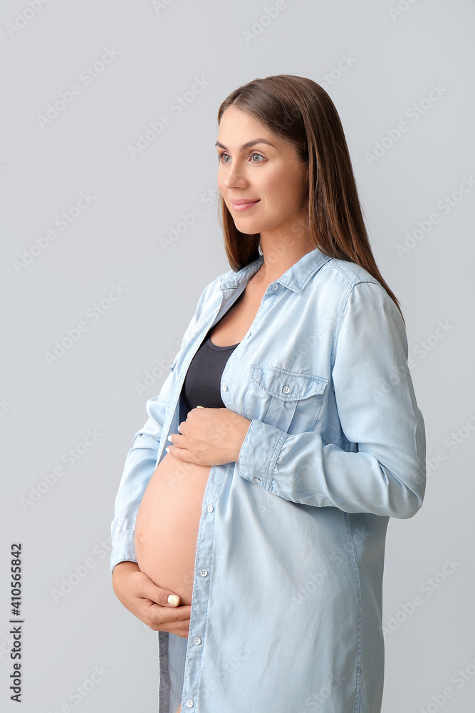 Beautiful pregnant woman on light background Beautiful pregnant woman on light background
