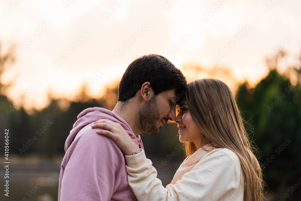 young couple facing each other and smiling young couple facing each other and smiling