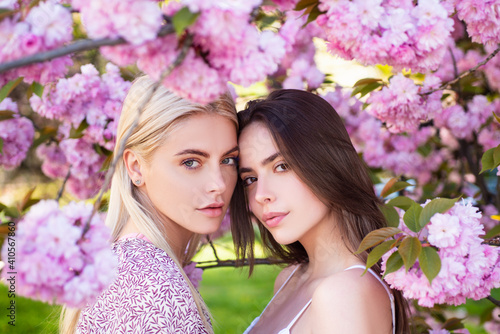 Girls in spring flowers. Fashion cosmetics and perfumes.