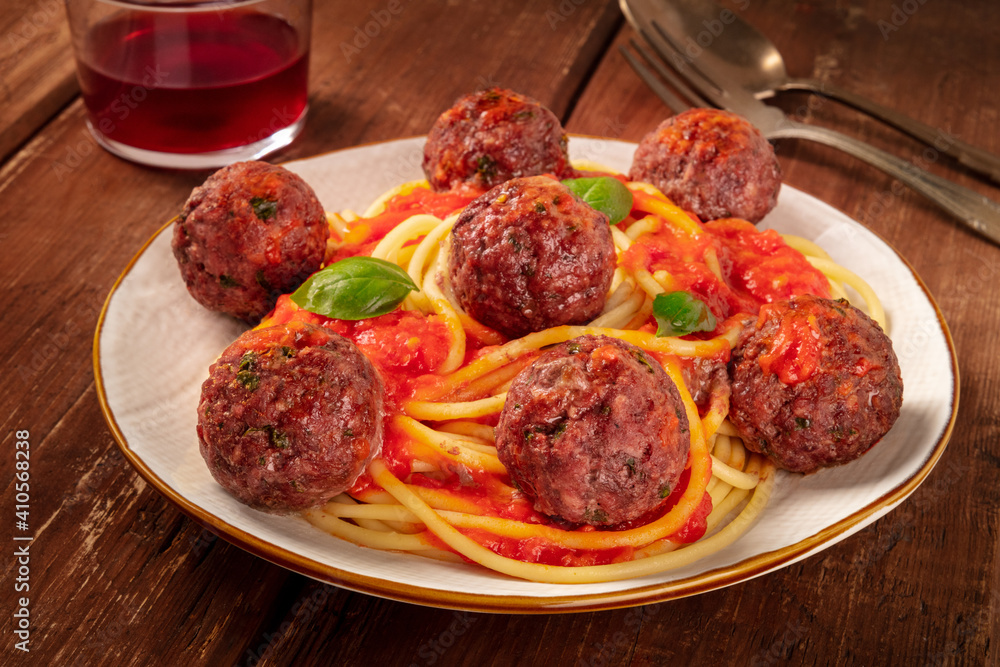 Meatballs with pasta, Italian dinner on a dark rustic wooden background Meatballs with pasta, Italian dinner on a dark rustic wooden background
