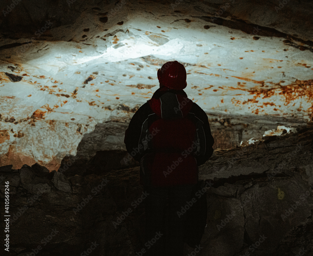 adventure through an Abandon mining cave in germany - person from back in middle frame