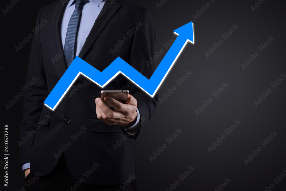 Businessman hold drawing on screen growing graph, arrow of positive growth icon.pointing at creative business chart with upward arrows.Financial, business growth concept Businessman hold drawing on screen growing graph, arrow of positive growth icon.pointing at creative business chart with upward arrows.Financial, business growth concept