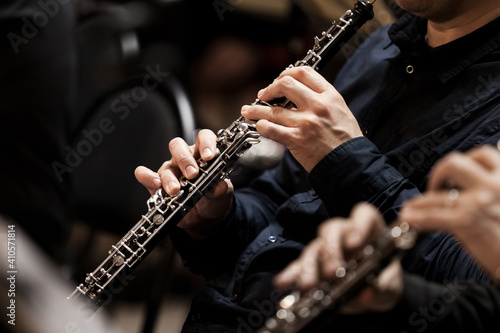  Hands of a musician playing the oboe in an orchestra 