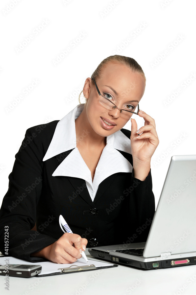 Young secretary sitting at table with laptop Young secretary sitting at table with laptop