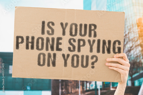 Obraz na plátně The question  Is your phone spying on you?  on a banner in hand with blurred background