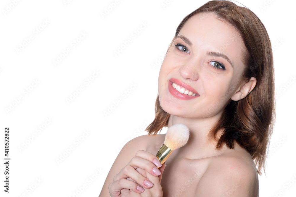 portrait of beautiful young woman posing with make up brush portrait of beautiful young woman posing with make up brush