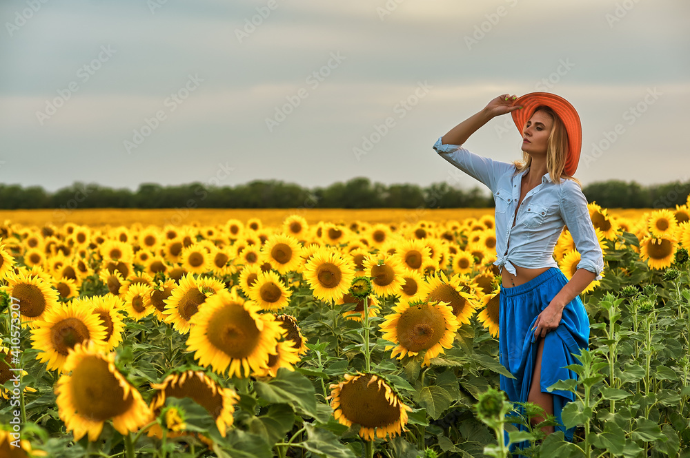Young woman on a walk in a field with sunflowers Young woman on a walk in a field with sunflowers