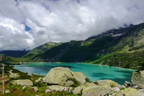 Fototapeta Naklejka Na Ścianę i Meble -  huge rocks and view to a amazing turquoise water reservoir in austria