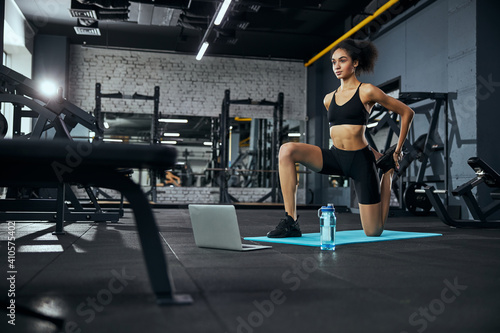 Kind female person doing physical training at gym