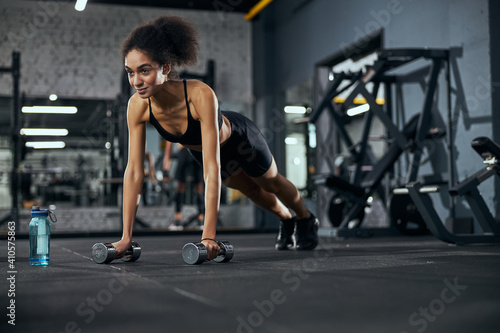 Strong female person keeping her body in plank © Svitlana