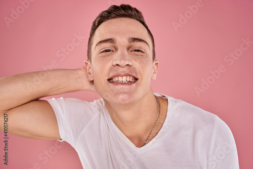 cheerful man in white t-shirt smile emotions close-up pink background studio © SHOTPRIME STUDIO