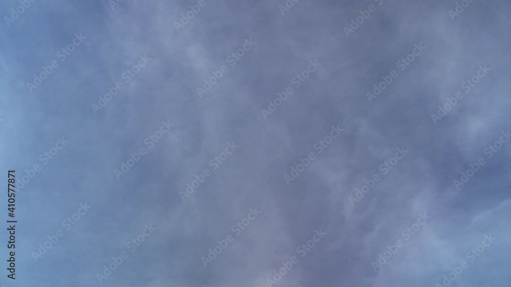 Diffuse clouds and jet vapor trail move in time-lapsed motion. Diffuse clouds and jet vapor trail move in time-lapsed motion.