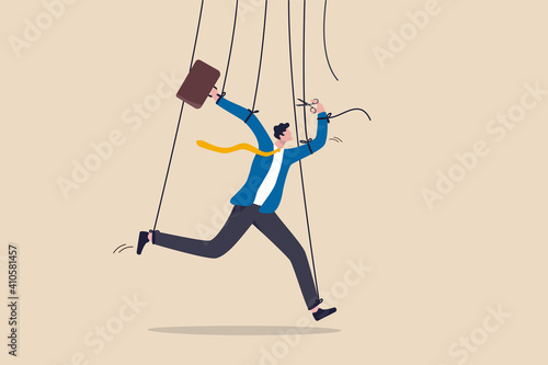 Freedom for work and decision making, authority to work independently, stop micromanagement, or people manipulation concept, businessman marionette, puppeteer use scissors to cut controlled strings.