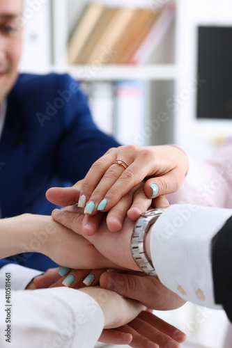 Group of people in suits crossed hands in pile for win closeup. White collar leadership, high five, cooperation initiative achievement, corporate life style, friendship deal, heap, stack concept
