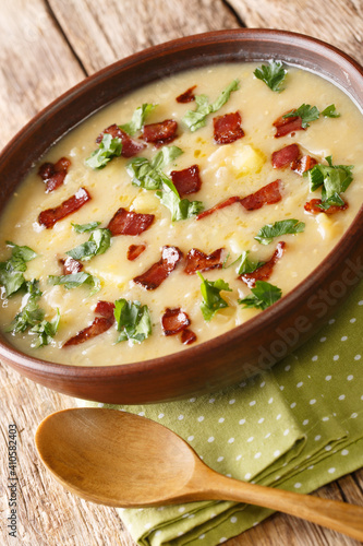 German pea and barley rumford soup with bacon close-up in a plate on the table. Vertical photo