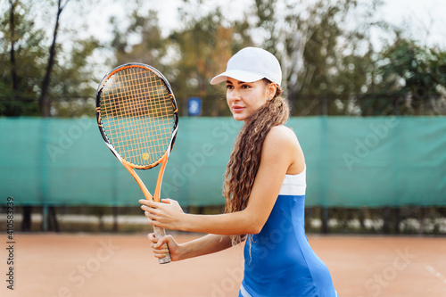 Woman tennis player is focused in a ready position. Athlete waiting for serve on a panoramic green background banner. Challenge and concentration in competition © Daria