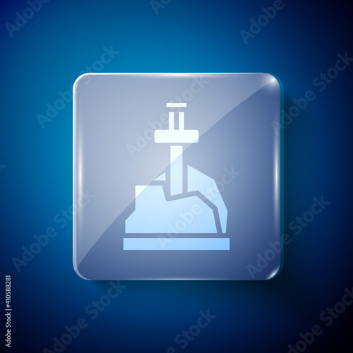 White Sword in the stone icon isolated on blue background. Excalibur the sword in the stone from the Arthurian legends. Square glass panels. Vector.