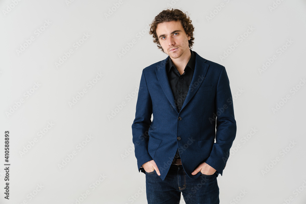 Confident handsome man in jacket posing and looking at camera Confident handsome man in jacket posing and looking at camera