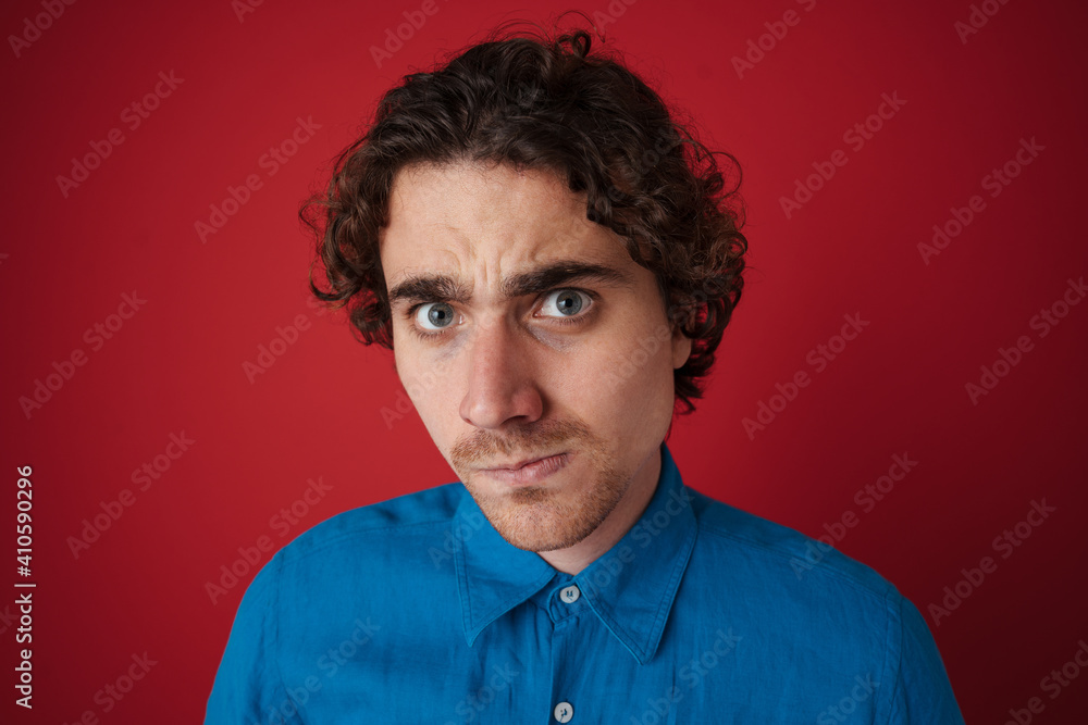 Fototapeta premium Stressed handsome man posing and looking at camera
