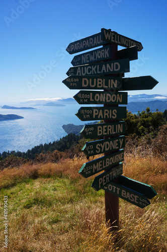 Wooden signpost in Queen Charlotte Track  showing distance to international cities around the World, New Zealand