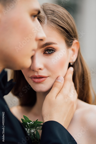 beautiful, gentle and happy bride and groom. man gently touches woman's face