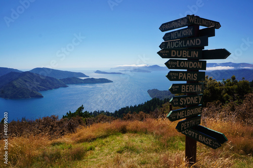 Wooden signpost in Queen Charlotte Track  showing distance to international cities around the World, New Zealand