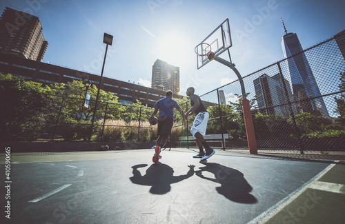 Two street basketball players playing hard on the court