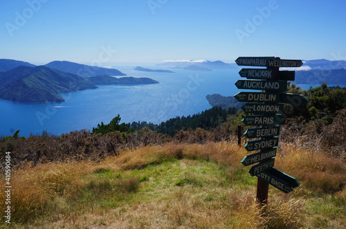 Wooden signpost in Queen Charlotte Track  showing distance to international cities around the World, New Zealand