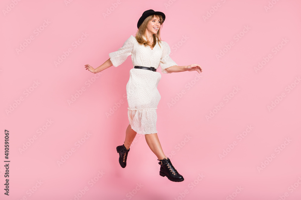 Full length photo of cute girl jump go wear retro hat dotted dress footwear isolated pink color background Full length photo of cute girl jump go wear retro hat dotted dress footwear isolated pink color background