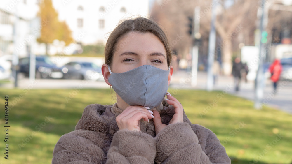 Beautiful stylish girl wear medical face mask on sunny city street. Young elegant happy hipster woman put on protective face mask outdoors. Urban fashion outfit, lifestyle. COVID-19 quarantine, travel Beautiful stylish girl wear medical face mask on sunny city street. Young elegant happy hipster woman put on protective face mask outdoors. Urban fashion outfit, lifestyle. COVID-19 quarantine, travel