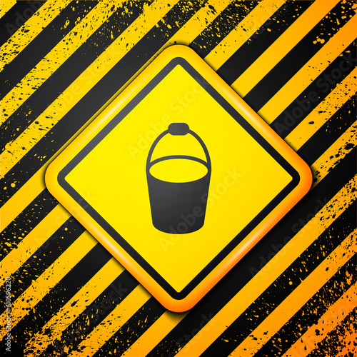 Black Fire bucket icon isolated on yellow background. Metal bucket empty or with water for fire fighting. Warning sign. Vector.