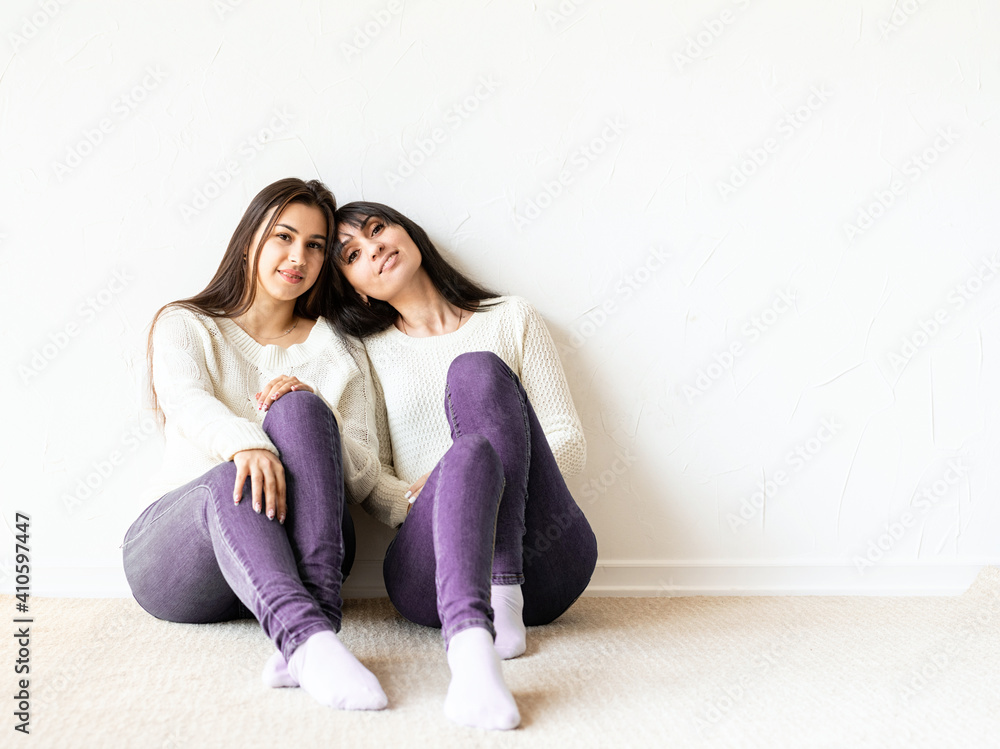 Two female best friends sitting together at home Two female best friends sitting together at home