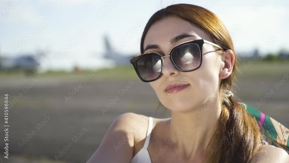 Beautiful Girl take off Sunglasses on the Background of the Plane
Beautiful Girl take off Sunglasses on the Background of the Plane