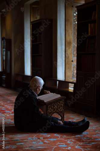 A man reciting Quran in Blue mosque (Sultan Ahmed mosque) Istanbul Turkey 