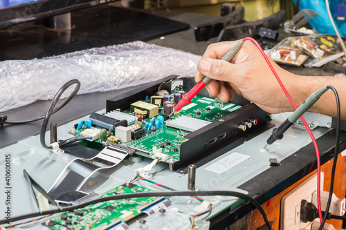 disassembly and repair of  lcd tv  by engineer or technician in shop, selective focus.