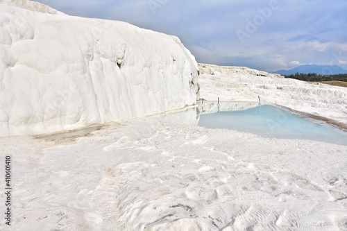 Amazing travertine pools and terraces in Pamukkale. Cotton castle in Turkey, Denizli Province. Beautiful natural view of famous white rocks in Pamukkale