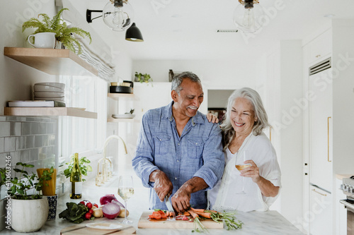 Elderly couple cooking in a kitchen photo