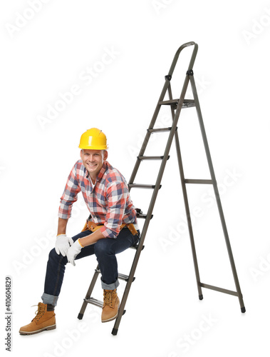 Professional constructor sitting on ladder on white background