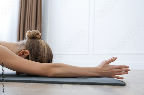 Young woman practicing restorative asana pose in yoga studio, closeup Fotobehang