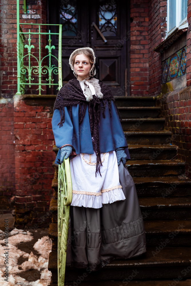 Outdoors portrait of a victorian lady walking old city