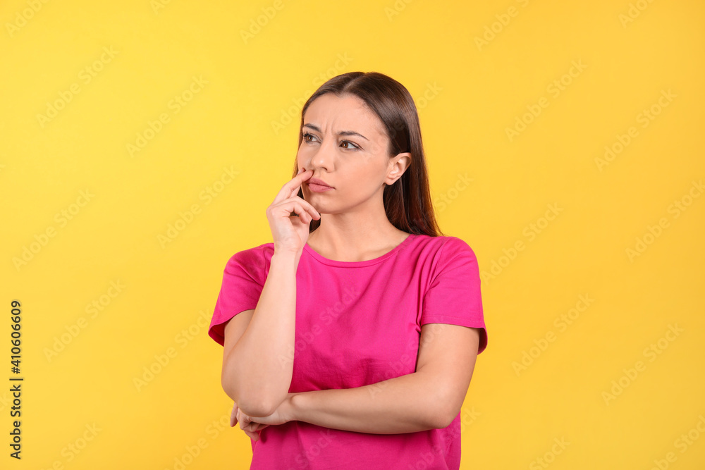 Portrait of stressed young woman on yellow background Portrait of stressed young woman on yellow background